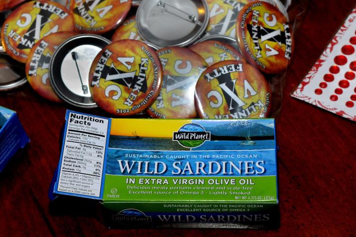 Empty boxes of wild sardines, attributed to General Flameous, sit by Winter Carnival buttons on a hotel room table where the vulcans gathered before going out and about in St. Paul on Wednesday Jan. 28, 2015.  (Pioneer Press: Jean Pieri)