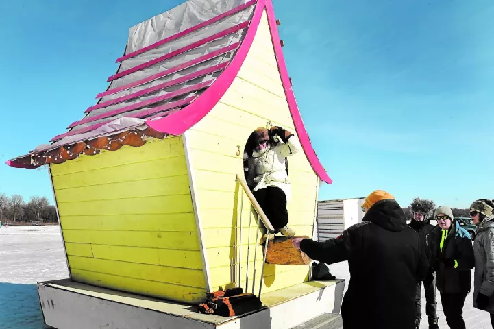 A visitor climbs into “The Birdhouse of Arthur J.E. Wren,” one of the structures in the Art Shanty Project on White Bear Lake, Sunday, Feb. 5, 2017. The Art Shanty Project, in its third year, is a chance to interact with artists in a non-gallery environment. (Pioneer Press: Scott Takushi)