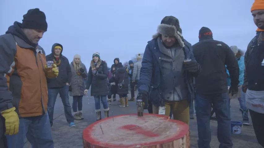 “Booze Traveler” (Jack Maxwell in the fur-flap cap with the hammer in his hand) visited the Winter Carnival Beer Dabbler. (Photo courtesy Travel Channel)