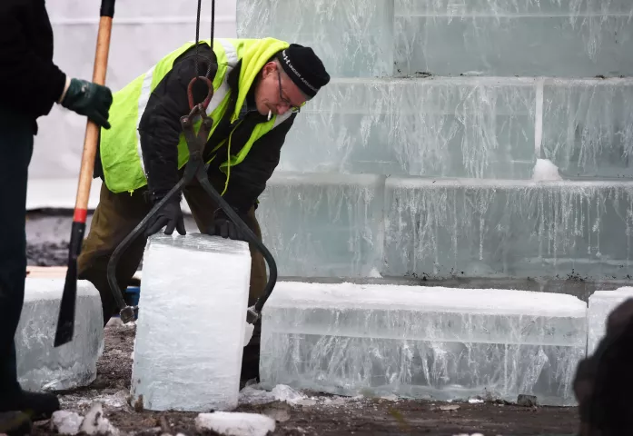 Rod Schmidt moves a block of ice into place, in St. Paul's Rice Park where the Winter Carnival Ice Castle is under construction. (Pioneer Press: Scott Takushi)