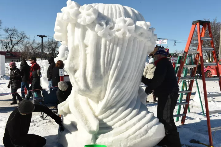 From left to right: Jon Baller, Joshual Baller and Curt Cook sculpt their "Winter Princess" out of snow at the Snow Park at the Minnesota State Fairgrounds in Falcon Heights during the 2017 Winter Carnival's events, Sunday, January 29, 2017. (Pioneer Press: Scott Takushi)