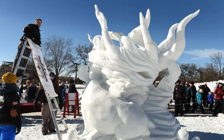 The "House of Thune" team admires their snow sculpture "When Nature Calls" at the Snow Park at the Minnesota State Fairgrounds in Falcon Height son Sunday, January 29, 2017. The team of Dusty Thune, David Aichinger and Jessica Turtle won First Place in the competition receiving a $1,000, a trophy, and the opportunity to represent Minnesota at the National Snow Sculpting Competition at Lake Geneva, Wisc. Winners of the national competition will advance to the International Snow Sculpting Competition. (Pionee