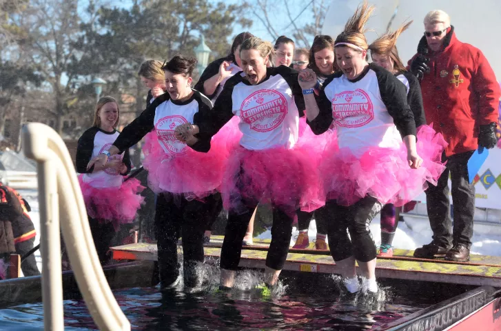 Employees of City &amp; County Credit Union take part in the Snow Park Plunge by diving into a pool of icy cold water at the Snow Park at the Minnesota State Fairgrounds, Sunday, January 29, 2017. (Pioneer Press: Scott Takushi)