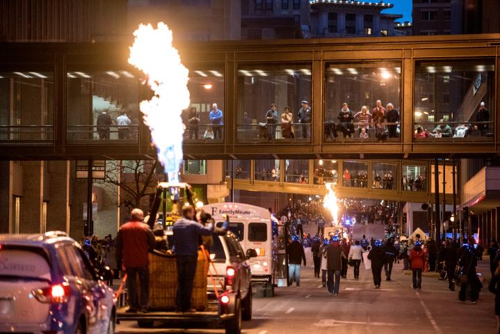 Crowds lines the streets of downtown St. Paul Saturday, Feb. 4, 2017, to watch the flaring of torches as part of the annual Winter Carnival Vulcan Victory Torchlight Parade. (Pioneer Press: Andy Rathbun)