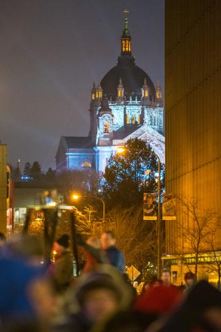 The Cathedral of St. Paul, lit blue for Red Bull Crashed Ice, is seen from the Winter Carnival Vulcan Victory Torchlight Parade in downtown St. Paul on Saturday, Feb. 4, 2017. (Pioneer Press: Andy Rathbun)