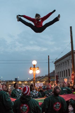 Kate Franssen-Hansen bounces into the air at the start of the Winter Carnival Vulcan Victory Torchlight Parade in downtown St. Paul on Saturday, Feb. 4, 2017. Pioneer Press: Andy Rathbun)