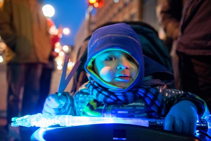 Giovanni Sanchez, 2, takes part in the fun of the Winter Carnival Vulcan Victory Torchlight Parade in downtown St. Paul on Saturday, Feb. 4, 2017. Giovanni was enjoying his first torchlight parade, said mom Kari Sanchez of St. Paul. (Pioneer Press: Andy Rathbun)