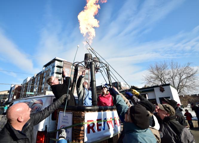 The Stramel family from Bloomington roasts marshmallows on extra long sticks over the flames of one of the hot air balloon burners. (John Autey / Pioneer Press)