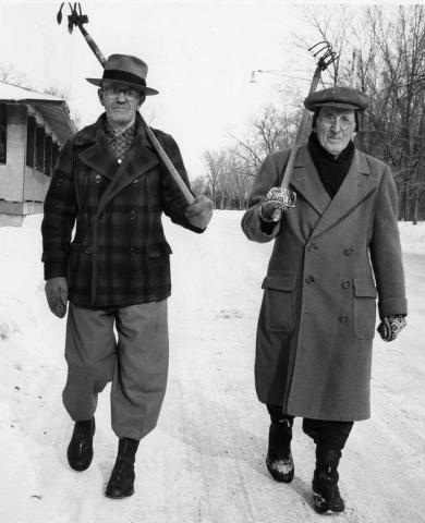 Armed with garden tools, Charles Shafer, left, and Ole Strand, both of St. Paul, walk down a snow-covered road in Como Park on their way to hunt treasure in 1955. (Pioneer Press file photo)