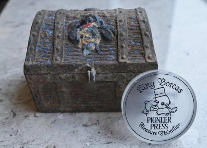 To mark the 60th anniversary of the Pioneer Press Treasure Hunt, this medallion, used in the past five hunts, was retired in 2012 and given away in an online drawing at the end of that year's hunt. The chest pictured here, not part of the drawing, held the first hunt's medallion in 1952. (Pioneer Press: Ginger Pinson)
