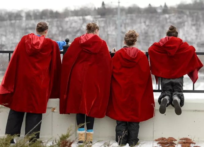 From left: 2016 Junior Miss Inver Grove Heights: Rachel Wagner, 15, and 2016 Inver Grove Heights Princess Liv Swenson, 16, Taylor Rose Ambrose, 10 and Hillary Tabuso, 10, all of Inver Grove Heights, look down at the Mississippi River as they wait for the beginning of the St. Paul Winter Carnival Grande Day Parade on Jan. 30 . (Pioneer Press: John Autey)