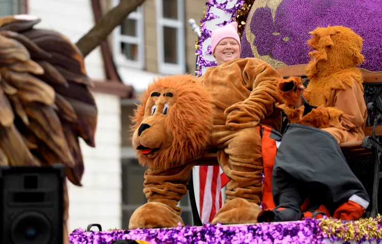 Shirley Olson, left, shares a laugh with her son, Spencer Olson, 11, atop the Lions Club District 5M6 parade float before the start of the St. Paul Winter Carnival Grande Day Parade in St. Paul on Jan. 30 (Pioneer Press: John Autey)
