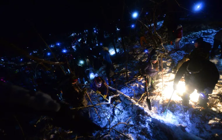 Hundreds of treasure hunters dig and sift the snow around a large overturned tree as they search for the Pioneer Press Treasure Hunt medallion at Bald Eagle-Otter Lake Regional Park late Wednesday, Feb. 3, 2016. (Pioneer Press: John Autey)