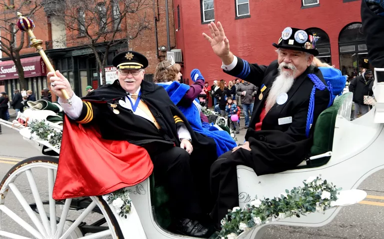 St. Paul Winter Carnival senior royalty, King Winter the 58th, Frank Gurney, and Prime Minister Dan Monson wave from their horse drawn carriage in the St. Paul Winter Carnival Grande Day Parade on Jan. 30. (Pioneer Press: John Autey)