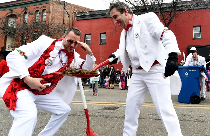 The Pooper Scoopers examine a pile of horse poop they scooped up from West 7th during the St. Paul Winter Carnival Grande Day Parade on Jan. 30. (Pioneer Press: John Autey)