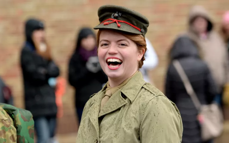 World War II Marine re-enactor Katie Barron, of St. Paul, smiles at the crowd during the Winter Carnival Grande Day Parade on Jan. 30. (Pioneer Press: John Autey)
