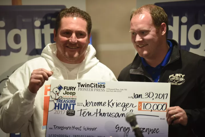 Jerome Krieger, winner of the 2017 Pioneer Press Medallion Hunt, shares a laugh with Joe Leonard of Fury Motors after Krieger was presented with his $10,000 prize inside the lobby of 10 River Park Plaza, which houses the paper's headquarters, Monday Jan. 30, 2017. (Pioneer Press: Dave Orrick)