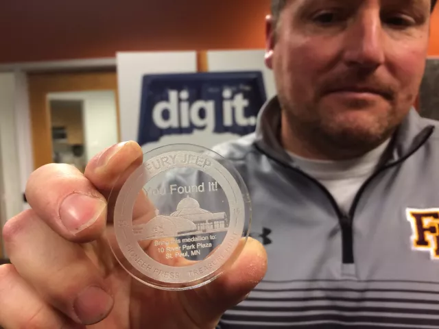 Jerome Krieger holds the 2017 Pioneer Press Treasure Hunt medallion he found at Keller Regional Park Monday, Jan. 30, 2017, inside the Pioneer Press offices. (Pioneer Press: Dave Orrick)