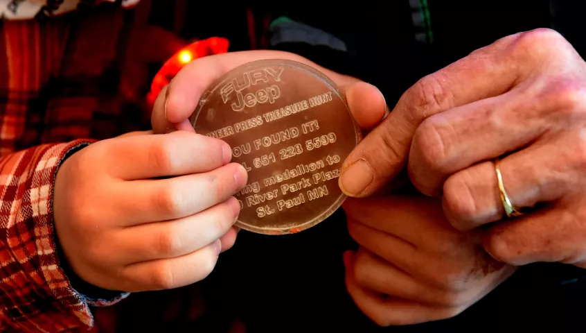 Treasure Hunt winner Rob Brass’s mother and sons hold his medallion after a news conference for the Pioneer Press Treasure Hunt medallion winner Thursday, Feb. 1, 2018. (Jean Pieri / Pioneer Press)