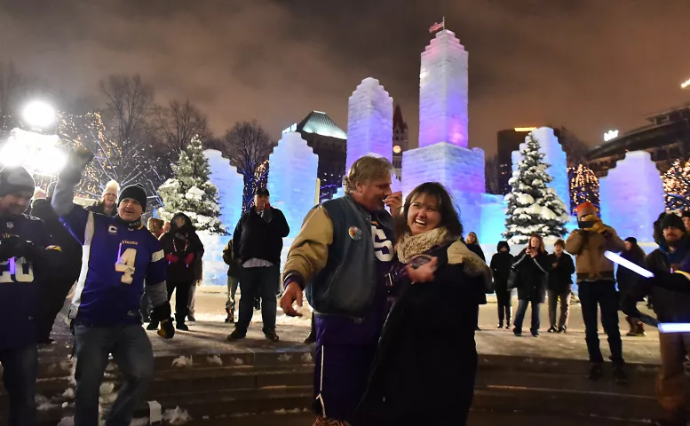 “He said yes!” says Janna Armstead after surprising her longtime boyfriend, Brad TeGantvoort, with a marriage proposal involving an elaborate flash mob involving music and dancers in front of the St. Paul Winter Carnival Ice Palace on Thursday evening, Jan. 25, 2018. The couple were joined by members of the “Cooler Crew,” St. Paul Pioneer Press Treasure Medallion hunter friends who were in on the surprise. (Pioneer Press / John Autey)