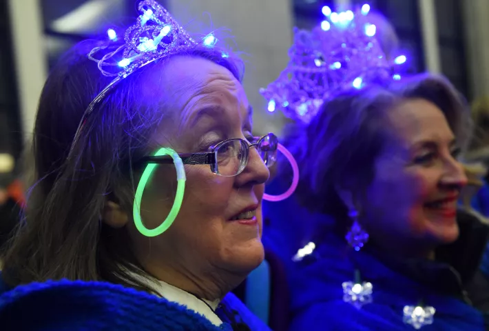 Senior Royalty Linda Jones wears earrings on her glasses at the St. Paul Winter Carnival Moon Glow Pedestrian Parade in St. Paul on Thursday, Jan. 25, 2018. With luminaries in hand to light the way, carnival dignitaries, ambassadors and organizers walk with local business leaders from the Securian Building on Sixth and Robert to Rice Park. (Jean Pieri / Pioneer Press)