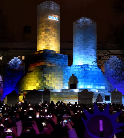 Parade goes pull out their phones to record the lighting of the 2018 Winter Carnival Ice Palace as it is lit after the St. Paul Winter Carnival Moon Glow Pedestrian Parade in St. Paul on Thursday, Jan. 25, 2018. (Jean Pieri / Pioneer Press)