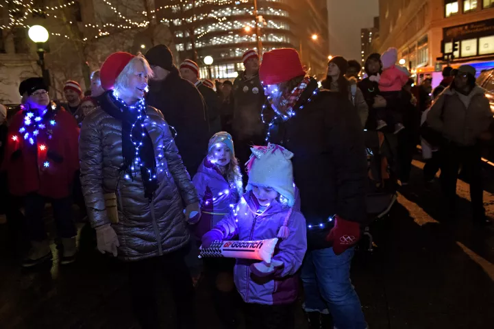 Mary Lou Rice, left, her daughter, Jen Gorski and twin granddaughters, Isabel and Sofie Fox march in the St. Paul Winter Carnival Moon Glow Pedestrian Parade in St. Paul on Thursday, Jan. 25, 2018. They took the bus from Woodbury and will take the bus back home. (Jean Pieri / Pioneer Press)