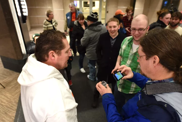 Jerome Krieger, winner of the 2017 Pioneer Press Medallion Hunt, lets others photograph the medallion and tells the story of how he found it to other treasure hunters inside the lobby of 10 River Park Plaza, which houses the paper's headquarters, Monday Jan. 30, 2017. (Pioneer Press: Dave Orrick)