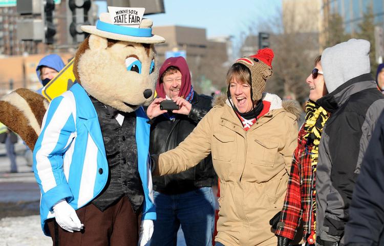 A gopher from the Minnesota State Fair dances with parade-goers at the Winter Carnival Grande Day Parade in St. Paul, Saturday January 25, 2014. (Pioneer Press: Jean Pieri)