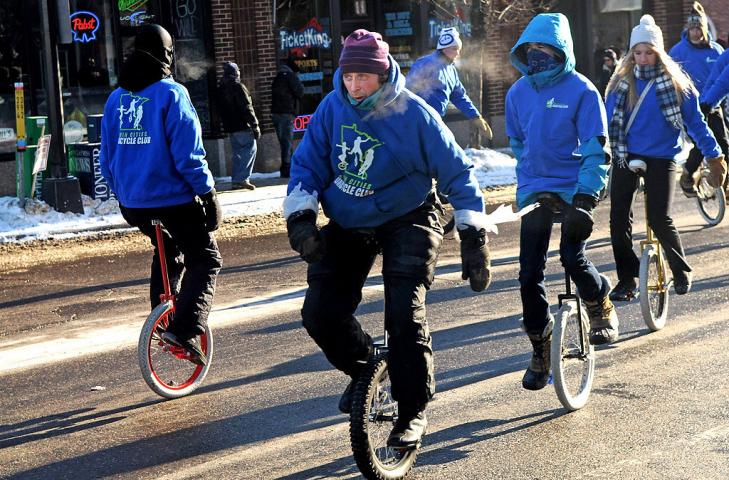 A bundled up Twin Cities Unicycle Club try to stay warm during the Winter Carnival Grande Day Parade in St. Paul, Saturday January 25, 2014. (Pioneer Press: Jean Pieri)