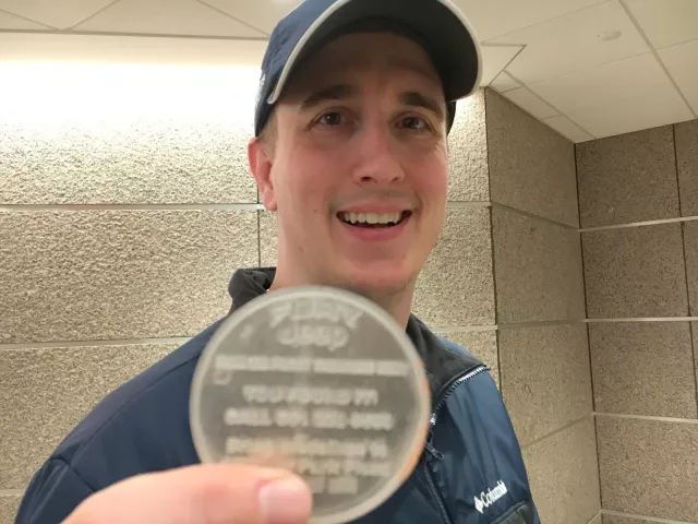 Pioneer Press Treasure Hunt winner Rob Brass of Chaska holds the medallion he unearthed from the bottom of a giant snowbank Wednesday night. He could win $10,000, thanks to sponsor Fury Jeep. (Lisa Legge / Pioneer Press)