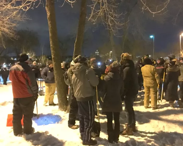 Treasure Hunters gather around the spot where the medallion was unearthed, between two V-shaped trees in the main parking lot of Harriet Island Regional Park in St. Paul, on Wednesday, Jan. 31, 2018. (Lisa Legge / Pioneer Press)