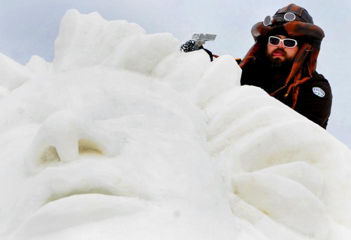 Dusty Thune concentrates on carving his team's snow sculpture called "Frozen" on Sunday morning before judging began at noon. The competition was held at the 2015 St. Paul Winter Carnival Snow Park at the Minnesota State Fairgrounds on Sunday, Jan. 25, 2015 . (Pioneer Press: Sherri LaRose-Chiglo)