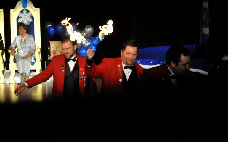 Members of the Vulcan Krewe exit the stage as they greet members of the audience and carry a torch prior to coronation. (Ginger Pinson / Pioneer Press)
