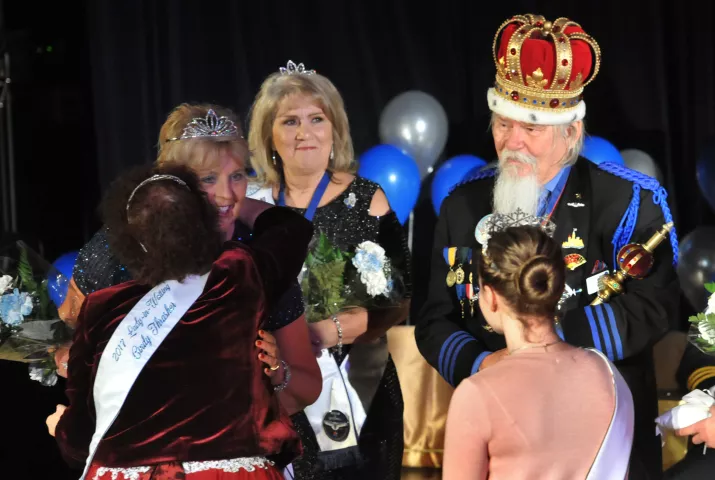 2017 Lady-in-Waiting Cindy Thasher hugs Judy Holmquist after being crowned Princess of Four Winds in the 2018 Senior Royalty Coronation. Rear center is Shirley Muelken, Prime Minister, and far right is King Winter the 60th, Dan Monson. (Ginger Pinson / Pioneer Press)