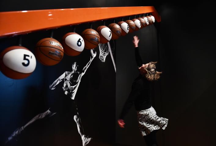 Science Museum of Minnesota employee Julie Marckel jumps as high as she can, testing her leaping ability in one of the interactive exhibits in the Sportsology exhibit. (Pioneer Press: Scott Takushi)