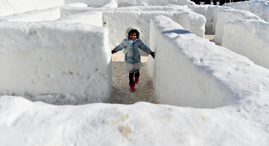 Aditi Chanmraj, 5, from Eagan figures her way out of the Vulcan Snow Maze at the Vulcan Snow Park at the Minnesota State Fair in Falcon Heights on Sunday, Feb, 11, 2018. Sunday was the last day of the St.. Paul Winter Carnival. (John Autey / Pioneer Press)