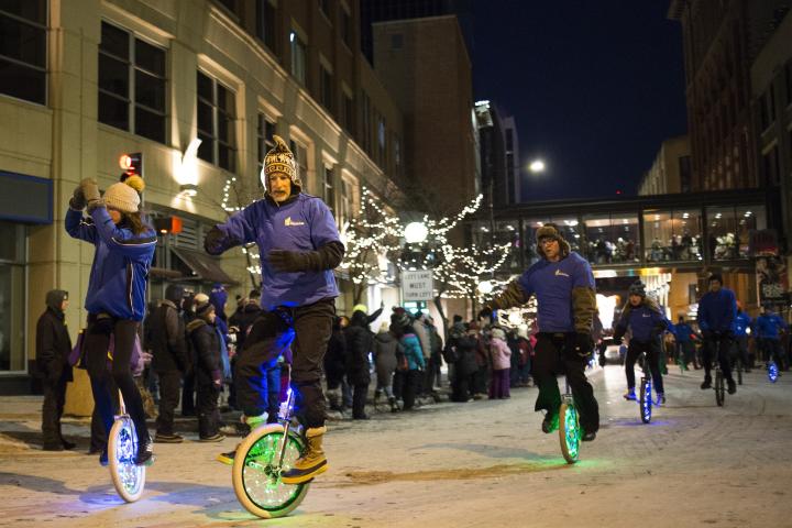 Unicyclists ride down Fifth Street. (Liam James Doyle / Special to the Pioneer Press)