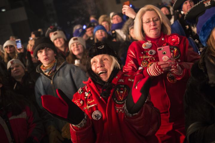 Oona Lanahan, center, lady of Vulcanus Rex LVI, cheers alongside other spectators as the Vulcans overthrow King Boreas. (Liam James Doyle / Special to the Pioneer Press)