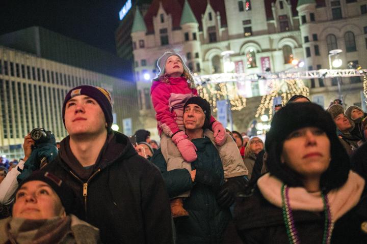 Jay Loven and his daughter Cassie, 7, center, of Bloomington watch a display of fireworks in Rice Park during the conclusion of the Vulcan Victory Torchlight Parade in downtown on Saturday, Feb. 10, 2018, bringing the St. Paul Winter Carnival to a close. (Liam James Doyle / Special to the Pioneer Press)