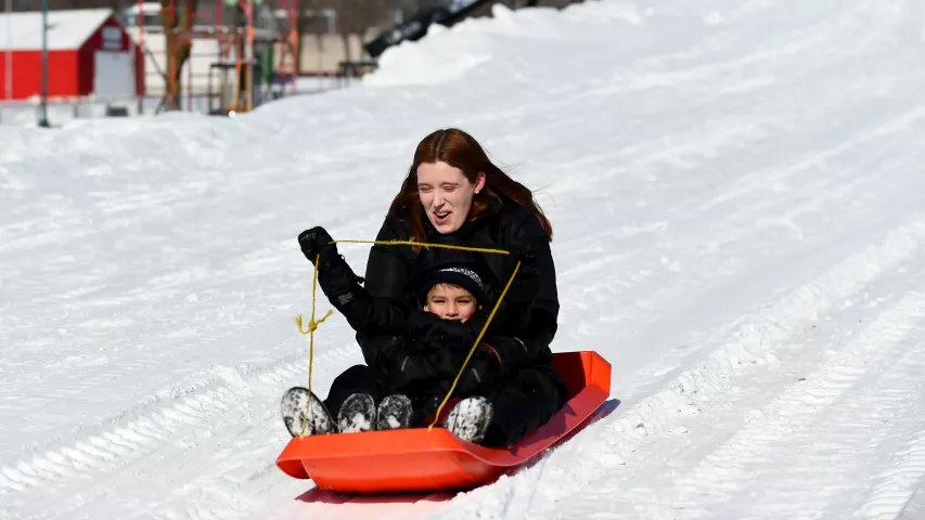 Joren Jagadeesan, 5, drives the sled as his mom Lisa holds on as they go down Snow Slide at the Vulcan Snow Park at the Minnesota State Fair in Falcon Heights on Sunday, Feb, 11, 2018. (John Autey / Pioneer Press)