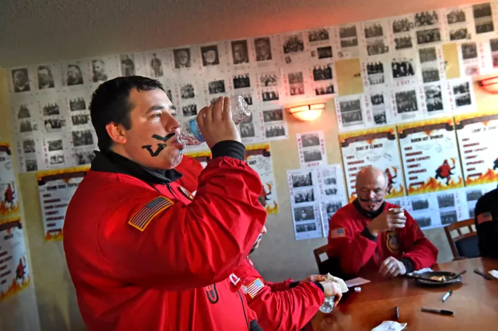 Mike Schmidt, Count Embrious, left, a third-generation Vulcan, gets hydrated before heading out to a school with the Vulcan Krewe. Schmidt's dad was a Vulcan in 1986 and his grandfather was Vulcanus Rex in 1954. (Pioneer Press: Jean Pieri)