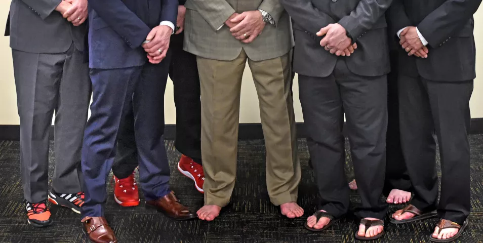 David Breen, Vulcanus Rex, center, and the Vulcan Krewe sport a mix of footwear choices as they pose for photo at early Wednesday morning at their "den" in St. Paul. The brown leather dress shoes are worn by Shawn Meyer, Grand Duke Fertilious. (Pioneer Press: Jean Pieri)