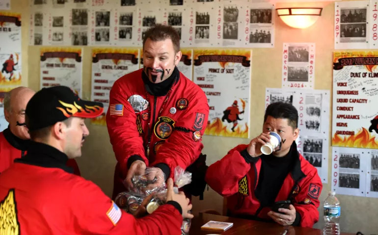 Chris Stengel, Baron Hot Sparkus, center, and other Vulcans load their pockets with Vulcan buttons to hand out at the stops they make. (Pioneer Press: Jean Pieri)