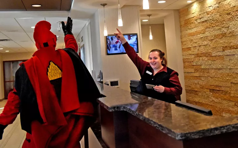 Denise Ring, the front desk agent at the Best Western Plus Capitol Ridge hotel in St. Paul, greets the Vulcans as they head through the lobby Wednesday. (Pioneer Press: Jean Pieri)