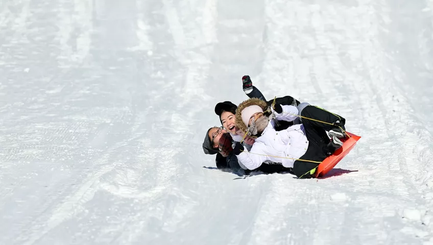 From front to back: Cousins Lee Thao 17, Pachai Vang ,16 and Changing Vang, 17, wipe out on the Snow Slide at the Vulcan Snow Park at the Minnesota State Fair in Falcon Heights on Sunday, Feb, 11, 2018 the last day of the St.. Paul Winter Carnival. (John Autey / Pioneer Press)
