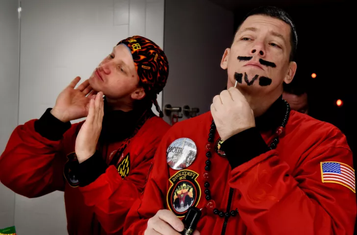 Joe Meives, Count Embrious, left, applies vaseline to his face as vulcan Tony Barrett, Grand Duke Fertilious, paints his face before heading out with the crew in St. Paul Wednesday, Jan. 31, 2018. They apply vaseline on their face first to protect from the wind and to make cleanup easier. (Jean Pieri / Pioneer Press)