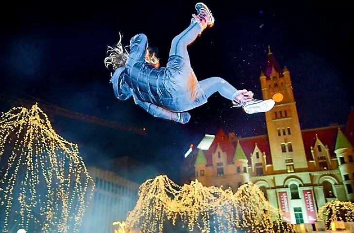 Rice Park and Landmark Center lit of the night sky as Moon Glow Parade goers were sent skyward by the St. Paul Bouncing Team during the 128th Saint Paul Winter Carnival Moon Glow Parade at Rice Park in St. Paul on Thursday, January 23, 2014. (Pioneer Press: Ben Garvin)