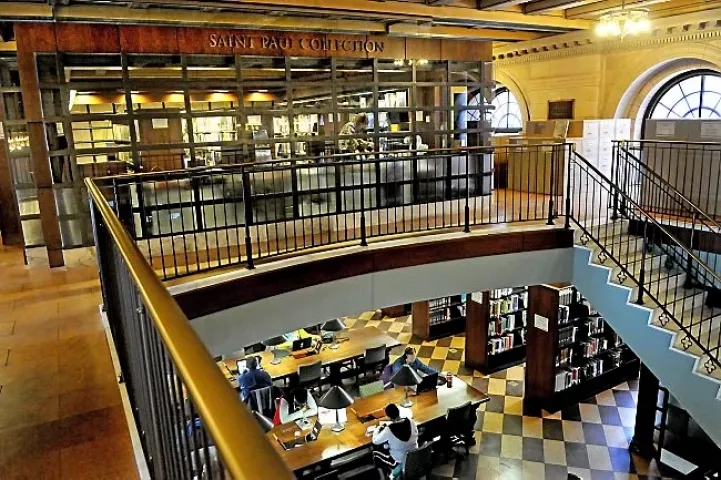 Nancy Tschida, top, searches through 1956 Winter Carnival newspaper clippings in the St. Paul Collection, a climate-controlled room on the second floor of Central Library in St. Paul on Thursday, Jan. 15, 2015. (Pioneer Press: Jean Pieri)
