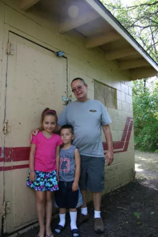 Grace Schueller (left) and her brother Isaac helped their grandfather Dale Fowser find the Heimatfest medallion at Lagoon Park this year. PHOTO BY MATHIAS BADEN